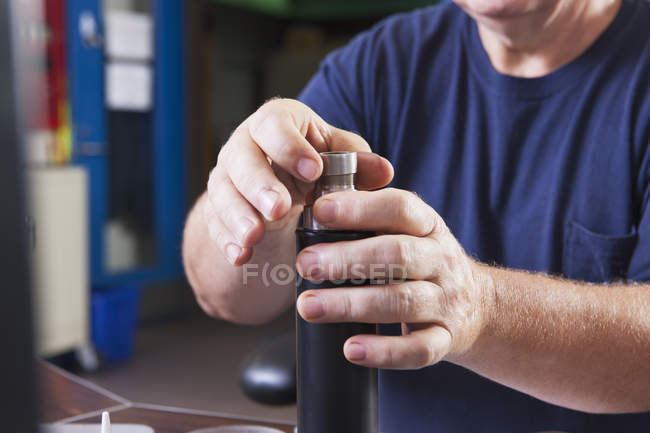 Engineer rebuilding an O2 electrochemical sensor probe in a laboratory — Stock Photo