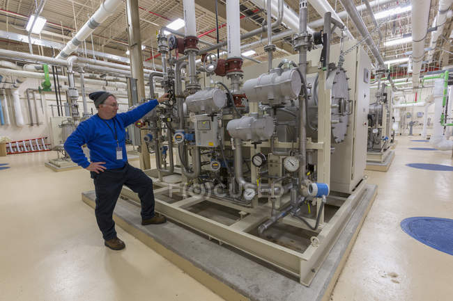 Water department engineer standing in chemical treatment room — Stock Photo
