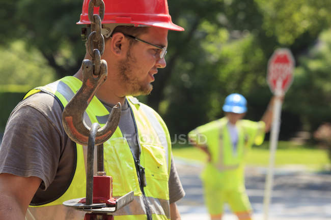 Construction worker moving gate valve on street — Stock Photo