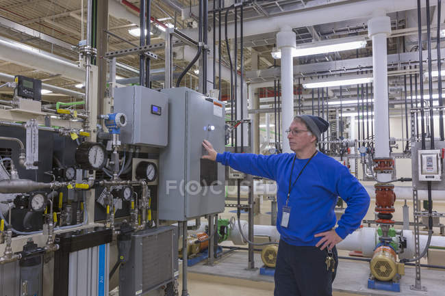 Water department engineer standing in chemical treatment room — Stock Photo