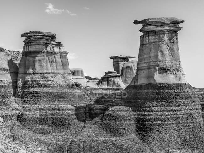 Each hoodoo on Hoodoo Trail is a sandstone pillar resting on a thick base of shale that is capped by a large stone; Drumheller, Alberta, Canada — Stock Photo