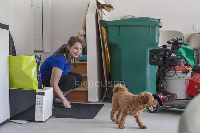 Mujer joven con parálisis cerebral jugando con su perro - foto de stock