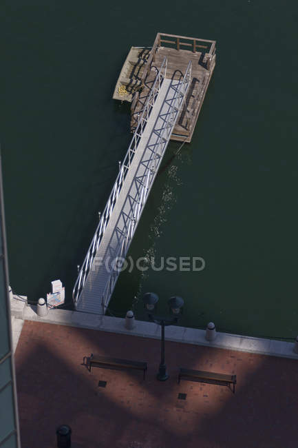 Aerial view of a wheelchair ramp leading out to a wooden dock on the water — Stock Photo