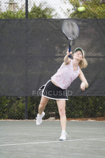 Senior woman playing tennis — Stock Photo