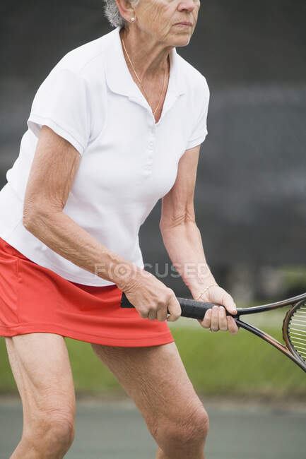 Donna anziana giocare a tennis — Foto stock