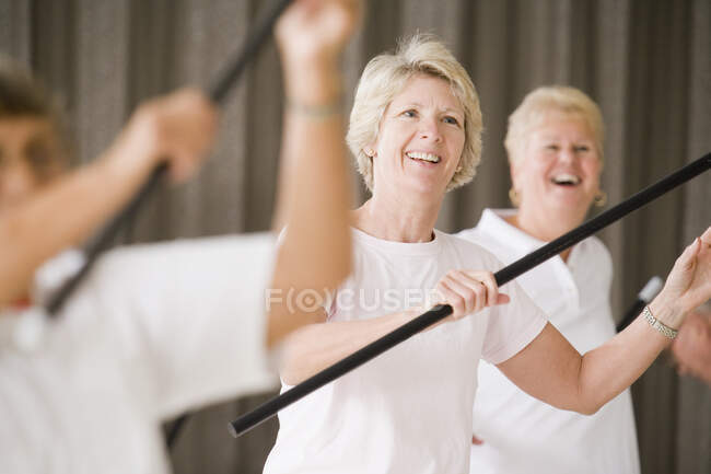 Gros plan d'une femme âgée qui fait de l'exercice dans un cours d'exercice — Photo de stock