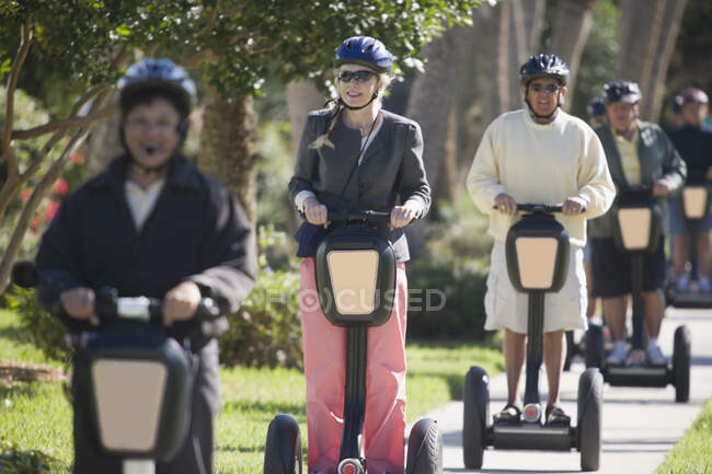 Tourists riding segways in the a garden — Stock Photo