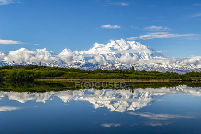 View of Denali and reflection in Reflection Pond taken from the park road while driving to Wonder Lake, Denali National Park and Preserve; Alaska, United States of America — Photo de stock