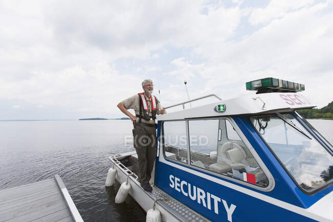 Security boat patrolling public water supply — Stock Photo