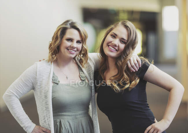 A young woman and her youth leader posing for a picture in a hallway of a church: Edmonton, Alberta, Canada — Stock Photo