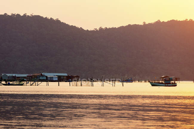 Човни і будівлі на воді під час яскравого рожевого заходу, пляж Старфіш; Фукуок, провінція Кьенцзян, В 