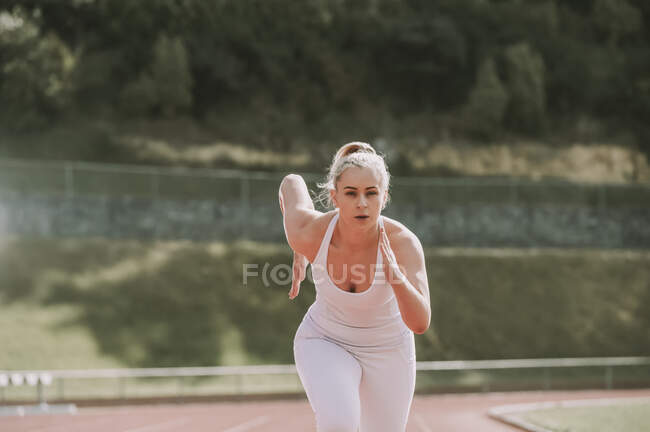 Woman running on a track; Wellington, New Zealand — Stock Photo