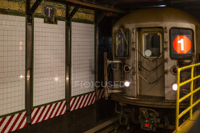 Subway underground on tracks beside tiled wall, Manhattan; New York City, New York, United States of America — Stock Photo