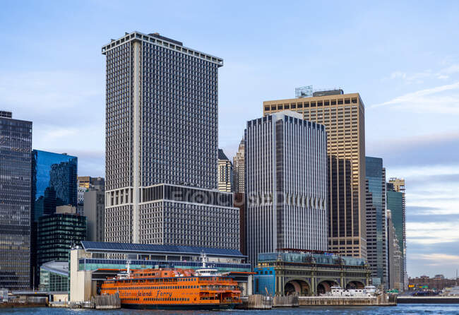 Downtown New York City and the Staten Island Ferry in the Whitehall Terminal; New York City, New York, United States of America — Stock Photo