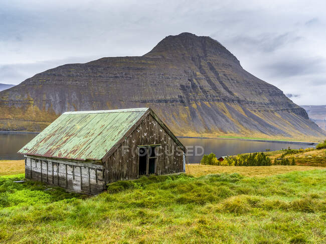 Edifício de águas residuais na orla de um fiorde no noroeste da Islândia, no município de Isafjarourbaer; Isafjarourbaer, região dos fiordes ocidentais, Islândia — Fotografia de Stock