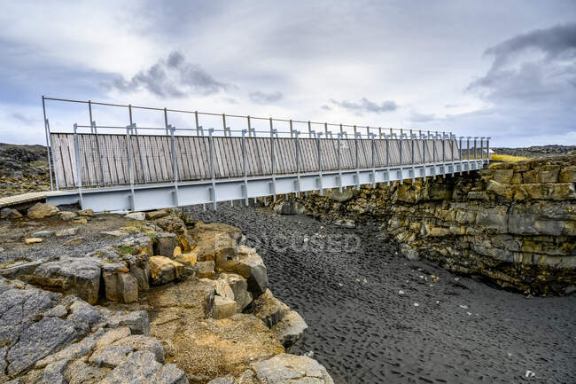 A metal walkway 'bridge between continents', between the North American plate and Eurasian plate; Reykjanesbaer, Southern Peninsula Region, Iceland — Stock Photo
