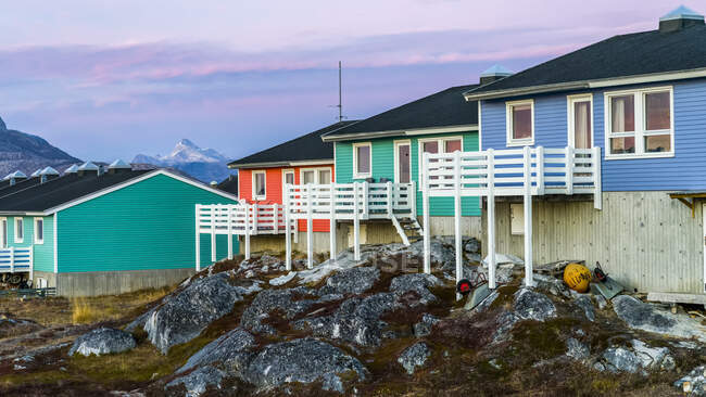 Colourful houses with decks on the back and mountains in the distance; Nuuk, Sermersooq, Greenland — Stock Photo