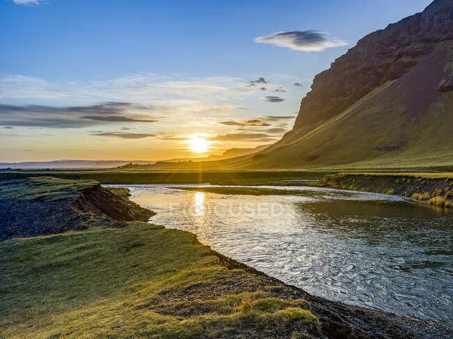 Beautiful sunrise over a river and lush landscape in Southern Iceland; Skaftarhreppur, Southern Region, Iceland — Stock Photo