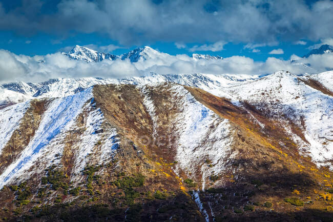 Caída de color montañas de Chugach espolvoreado con nieve, picos irregulares en el fondo. Chugach State Park, South-central Alaska en otoño; Anchorage, Alaska, Estados Unidos de América - foto de stock