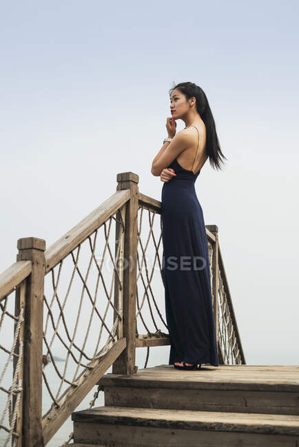 Jeune femme modèle debout posant à l'extérieur ; Xiamen, Chine — Photo de stock