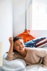 Young attractive asian woman lying in bed — Stock Photo