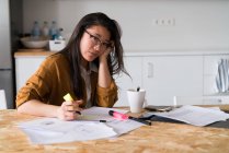 Chinese woman at home working looking at the camera — Stock Photo