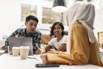 Young multicultural business people at meeting in modern office — Stock Photo