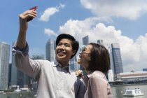 Young asian couple taking selfie in Singapore — Stock Photo