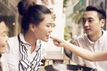 Junge glückliche asiatische Familie teilt traditionelles Essen — Stockfoto