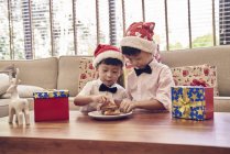 Happy asian brothers celebrating christmas together — Stock Photo