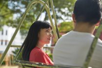 Couple having a quiet time on a swing in Tanjong Pagar, Singapore — Stock Photo