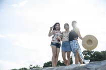 Three young ladies enjoying the breeze. — Stock Photo