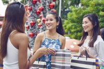 Young attractive asian women at christmas shopping — Stock Photo