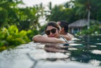RELEASES Fröhlich jung asiatisch pärchen relaxen im ein pool — Stockfoto