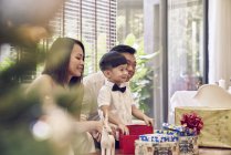 Happy young asian family celebrating christmas together — Stock Photo