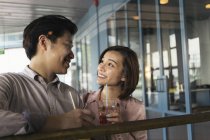Young asian couple spending time together with drink — Stock Photo