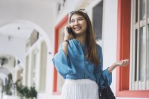 Attractive young asian girl using smartphone — Stock Photo