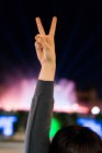 Cropped image of woman showing peace gesture — Stock Photo