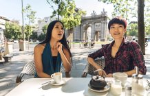 Asian women having coffee at a cafe — Stock Photo