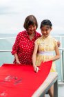 Grandmother and granddaughter drawing calligraphy hieroglyphs — Stock Photo