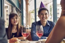 Company of young asian friends together celebrating christmas — Stock Photo