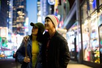 Young asian couple  looking around in time square — Stock Photo