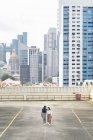 Young casual asian girls walking on roof — Stock Photo