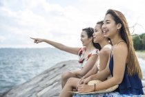 Three young ladies chilling at the beach. — Stock Photo