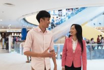 Attractive young asian couple walking together — Stock Photo