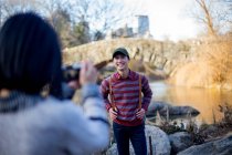 Asian tourist taking photo in central park. — Stock Photo