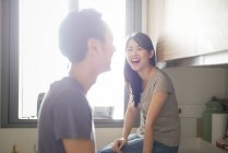 Mature asian casual couple on kitchen together — Stock Photo