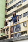 Young casual asian girls posing at camera — Stock Photo