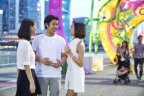 Three young asian friends having fun at chinese new year, Singapore — Stock Photo