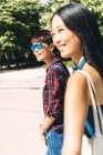 Two Asian women walking in the park — Stock Photo